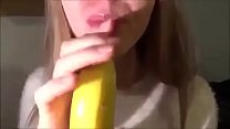 Cute Girl Sucking a Banana with Condom